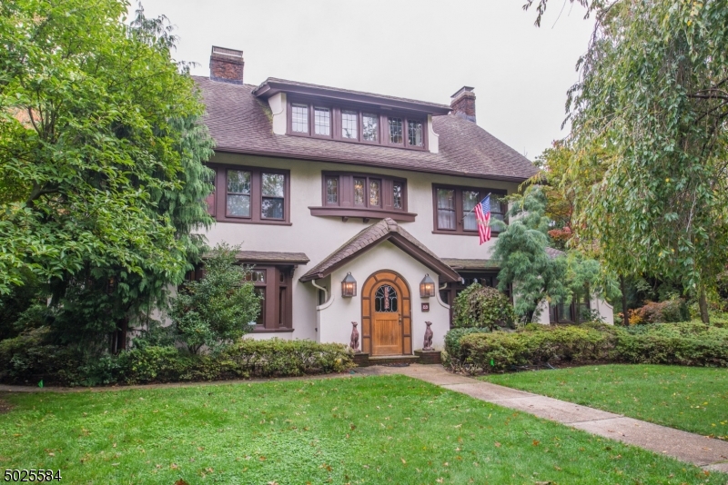 89 Ridgewood Avenue Glen Ridge, NJ 07028 - Photo 2 of 21 a front view of a house with a garden