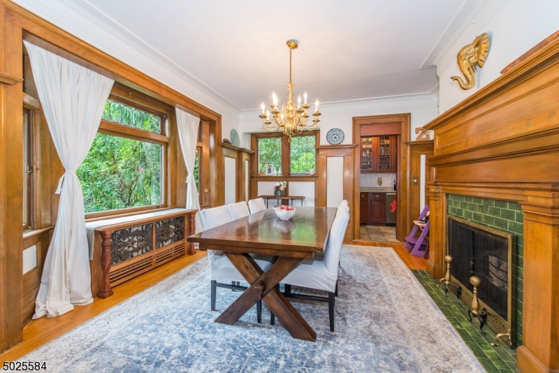 89 Ridgewood Avenue Glen Ridge, NJ 07028 - Photo 7 of 21 a dining room with furniture a chandelier and wooden floor