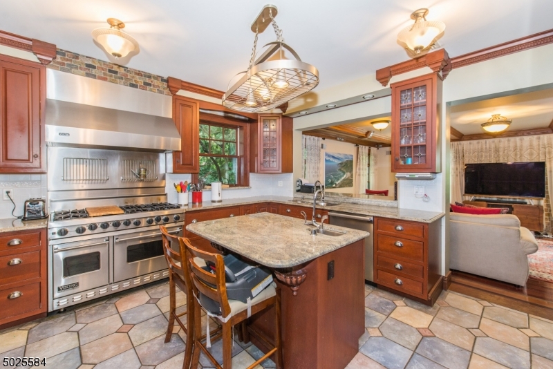 89 Ridgewood Avenue Glen Ridge, NJ 07028 - Photo 9 of 21 a kitchen with a stove a sink and a refrigerator