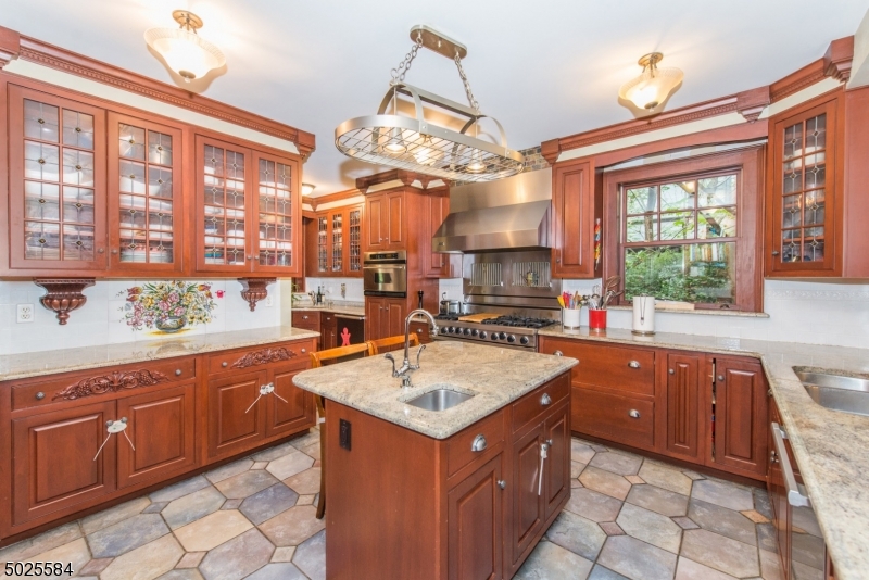 89 Ridgewood Avenue Glen Ridge, NJ 07028 - Photo 10 of 21 a kitchen with a sink stove and cabinets