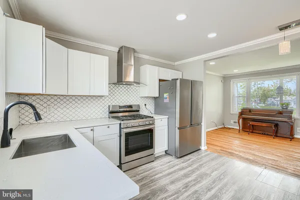 a kitchen with a stove a refrigerator and a sink