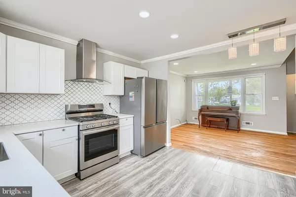 a kitchen with stainless steel appliances granite countertop a stove and a refrigerator