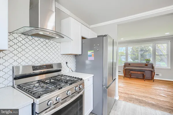 a kitchen with stainless steel appliances granite countertop a stove and a refrigerator