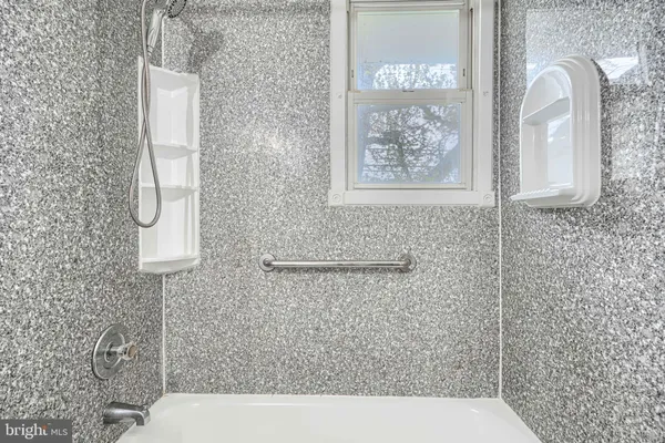 a bathroom with a sink a light fixture and a mirror