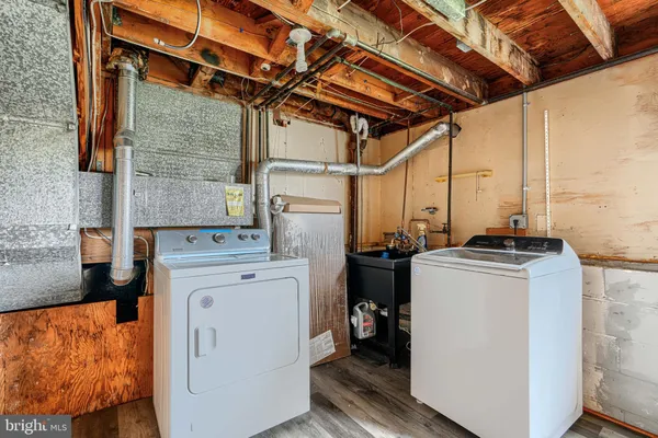 a kitchen with stainless steel appliances kitchen island granite countertop a refrigerator and a stove