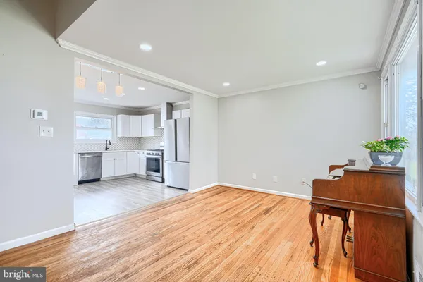 a room with stainless steel appliances kitchen island sink stove and cabinets