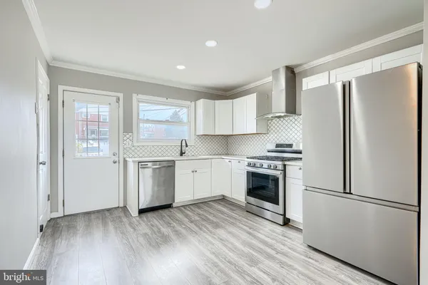 a kitchen with a refrigerator sink and cabinets