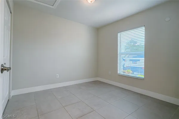 a bathroom with a granite countertop sink a toilet and mirror