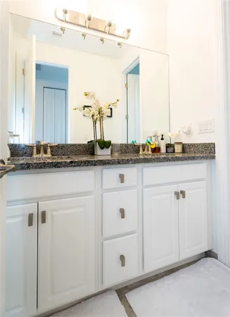 a kitchen with a sink a stove and cabinets