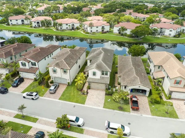 an aerial view of a house with a garden and lake view