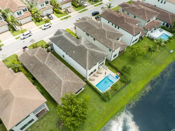 an aerial view of residential building and lake