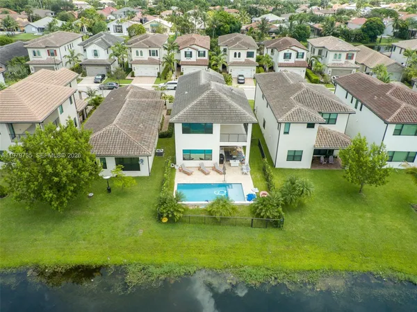 an aerial view of a house with a yard
