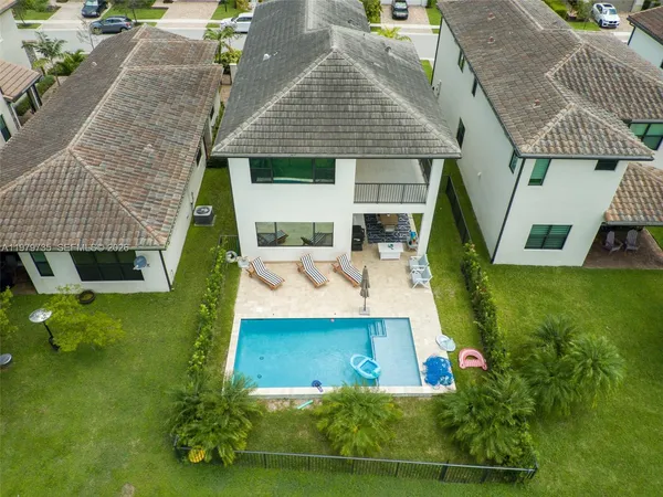 an aerial view of residential houses with outdoor space