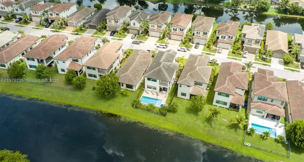 a aerial view of a house with a yard and potted plants