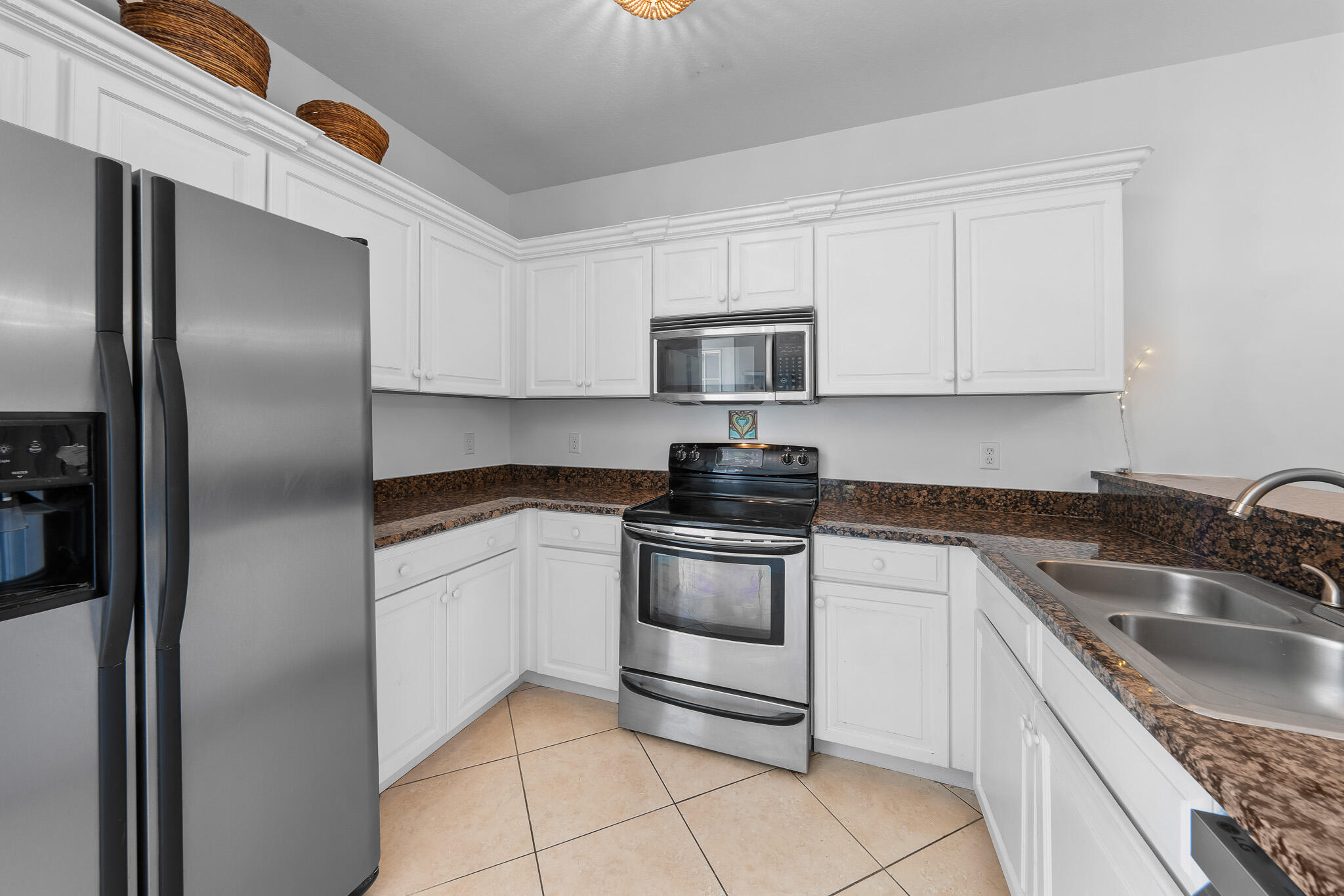 34 Heron's Watch Way, Unit 7205 Santa Rosa Beach, FL 32459 - Photo 4 of 49 a kitchen with stainless steel appliances granite countertop a sink stove and refrigerator