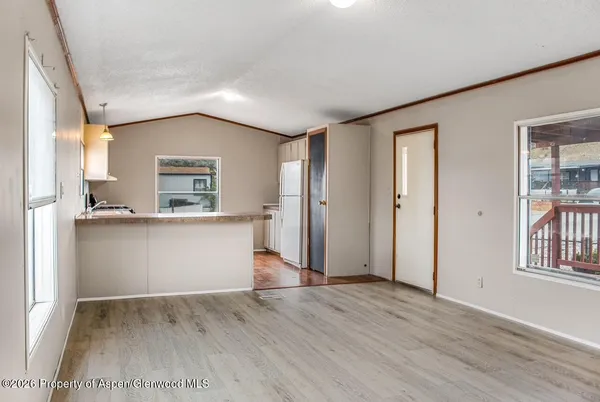 an empty room with wooden floor and a window