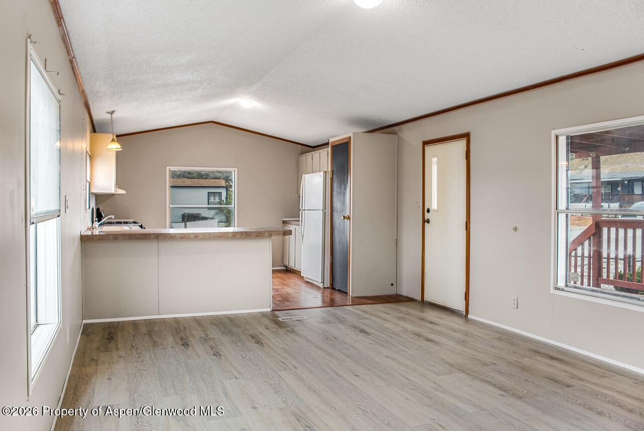 200 West 20th Street, Unit B17 Rifle, CO 81650 - Photo 4 of 12 an empty room with wooden floor and a window