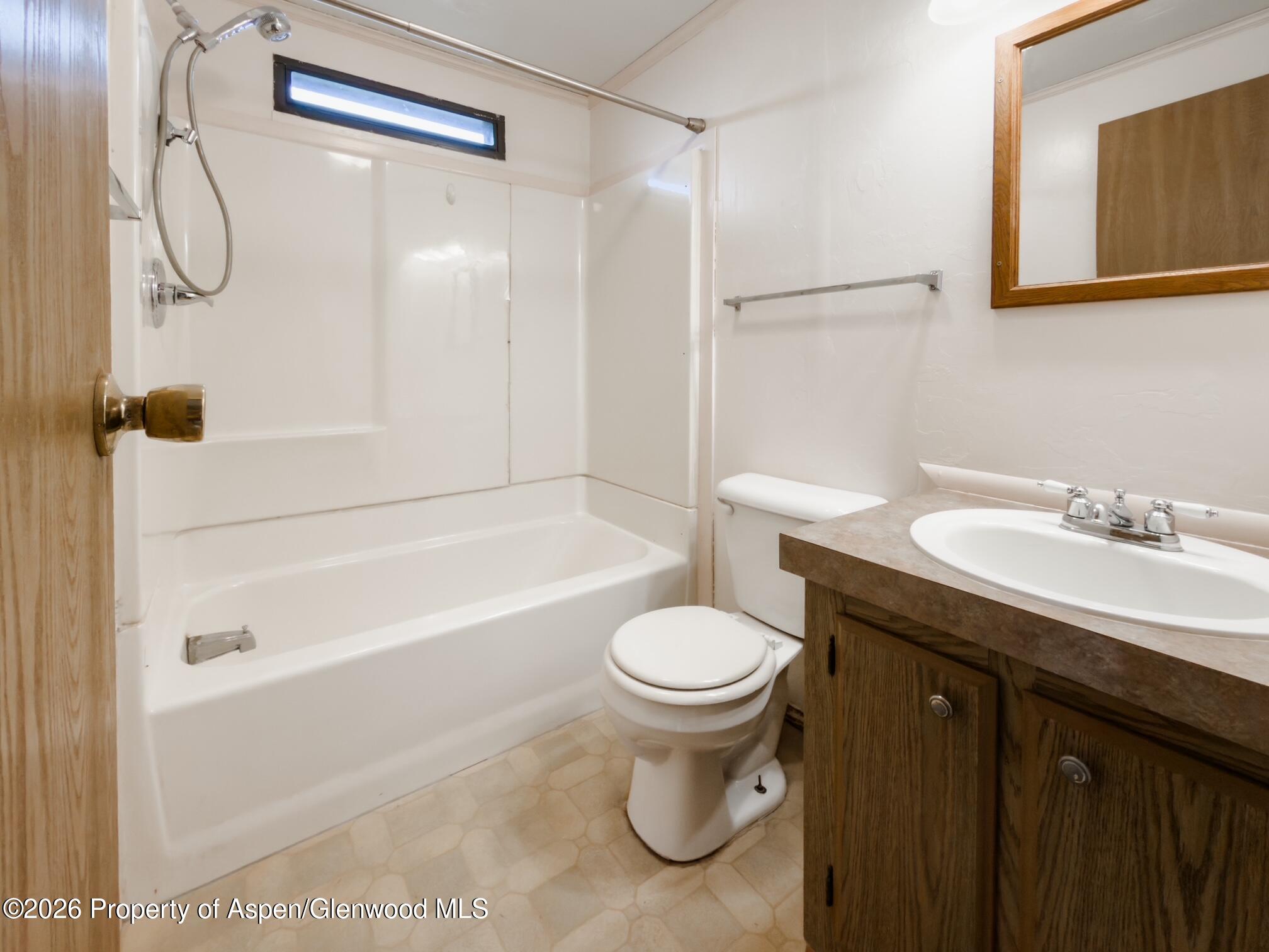 200 West 20th Street, Unit B17 Rifle, CO 81650 - Photo 6 of 12 a bathroom with a sink a toilet and a bathtub