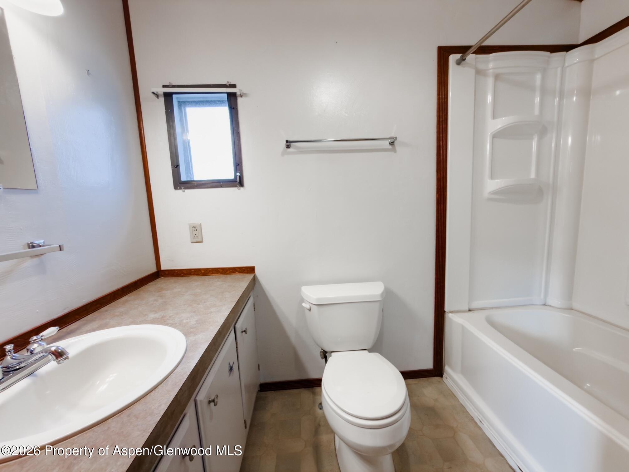 200 West 20th Street, Unit B17 Rifle, CO 81650 - Photo 7 of 12 a bathroom with a sink toilet and shower