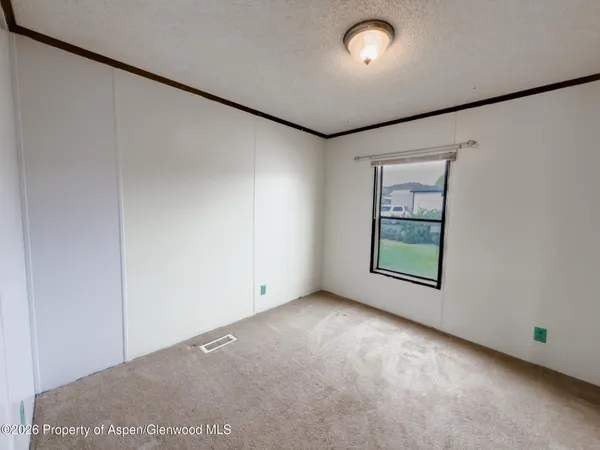 an empty room with windows and closet