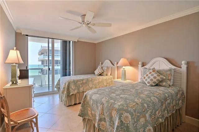 a bedroom with a bed a lamp and a large window