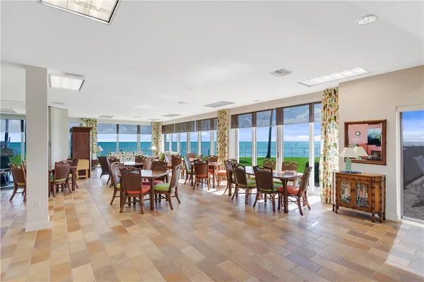 a living room with furniture large window and flat screen tv