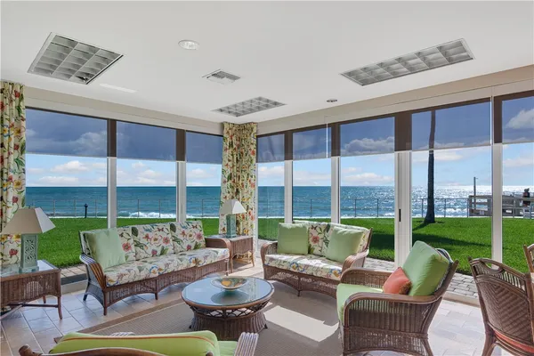 a view of a livingroom with lounge chair and a large window