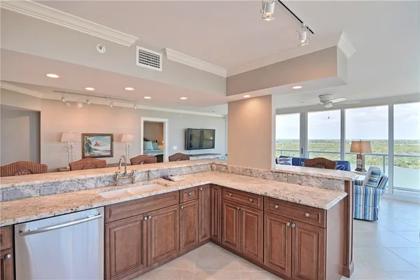 a kitchen with a sink and a large window