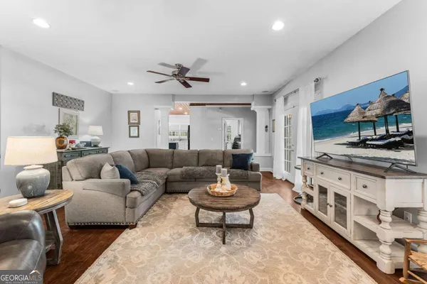 a living room with furniture a fireplace and a flat screen tv