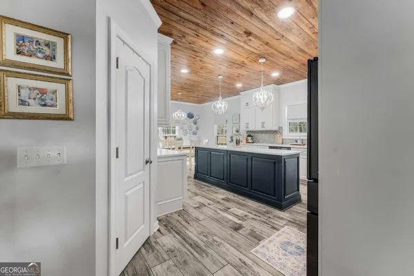 a kitchen with granite countertop white cabinets and white appliances