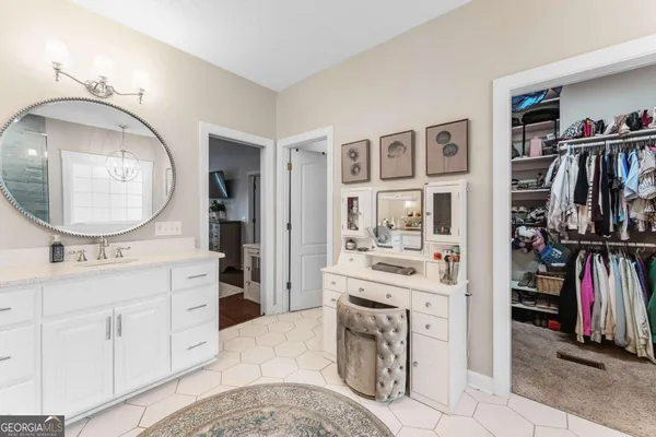 a bedroom with a bed table and a mirror