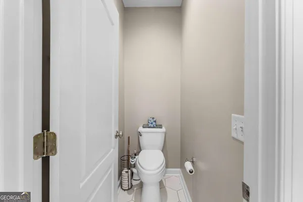 a bathroom with a double vanity sink toilet mirror and shower