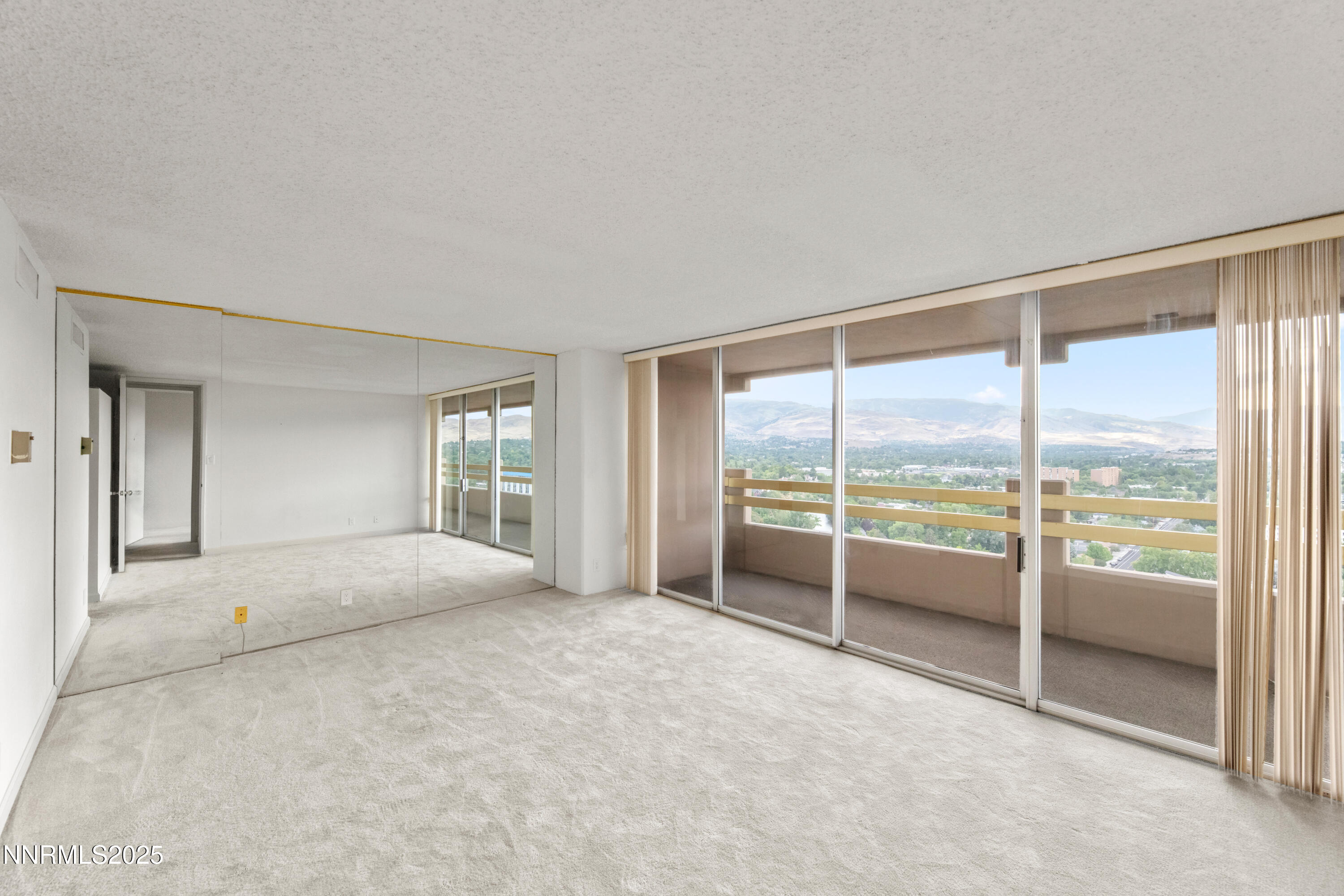 100 North Arlington Avenue, Unit 23P Reno, NV 89501 - Photo 13 of 31 an empty room with sliding glass door and shower