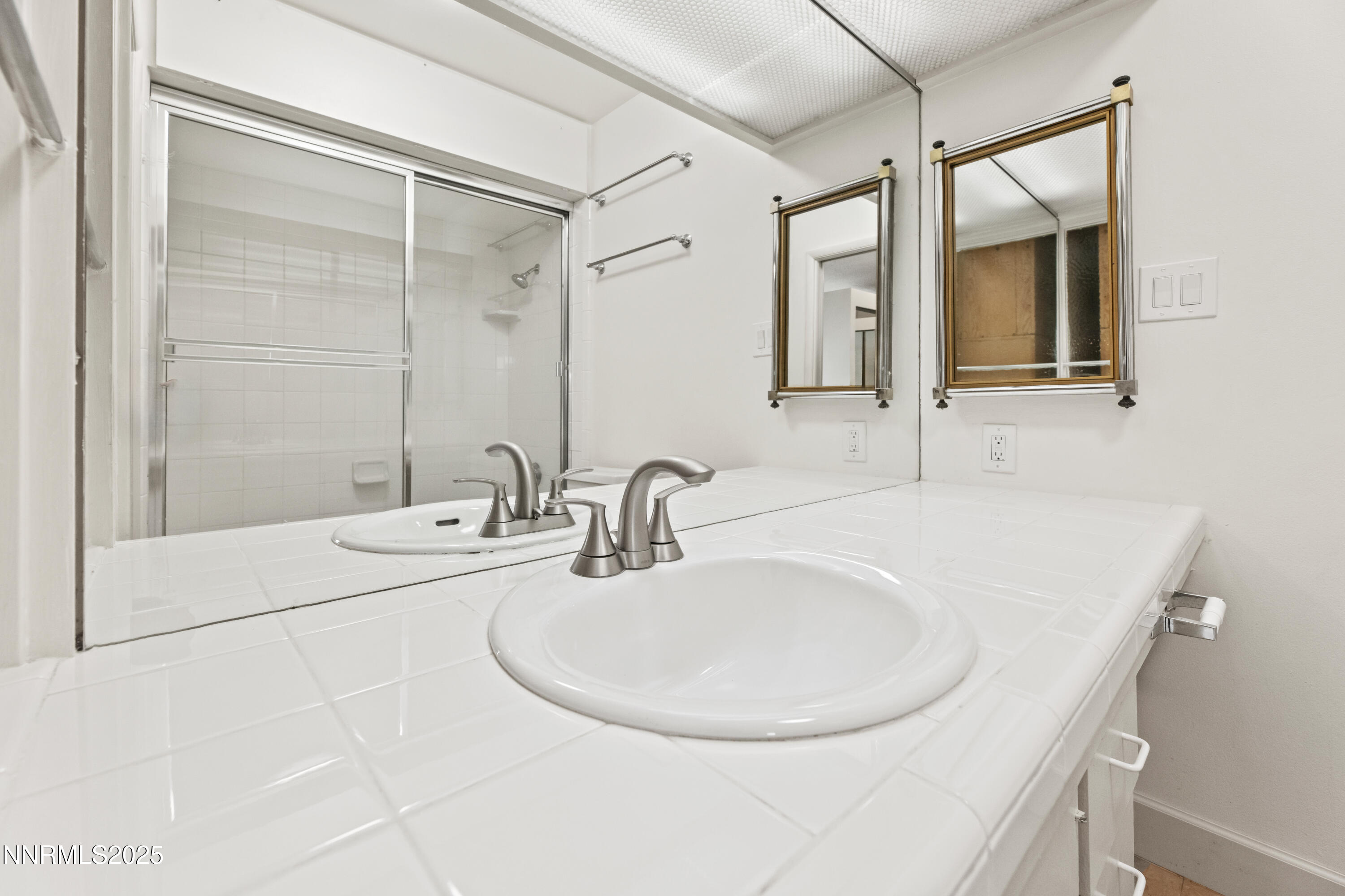 100 North Arlington Avenue, Unit 23P Reno, NV 89501 - Photo 16 of 31 a bathroom with a sink and a mirror