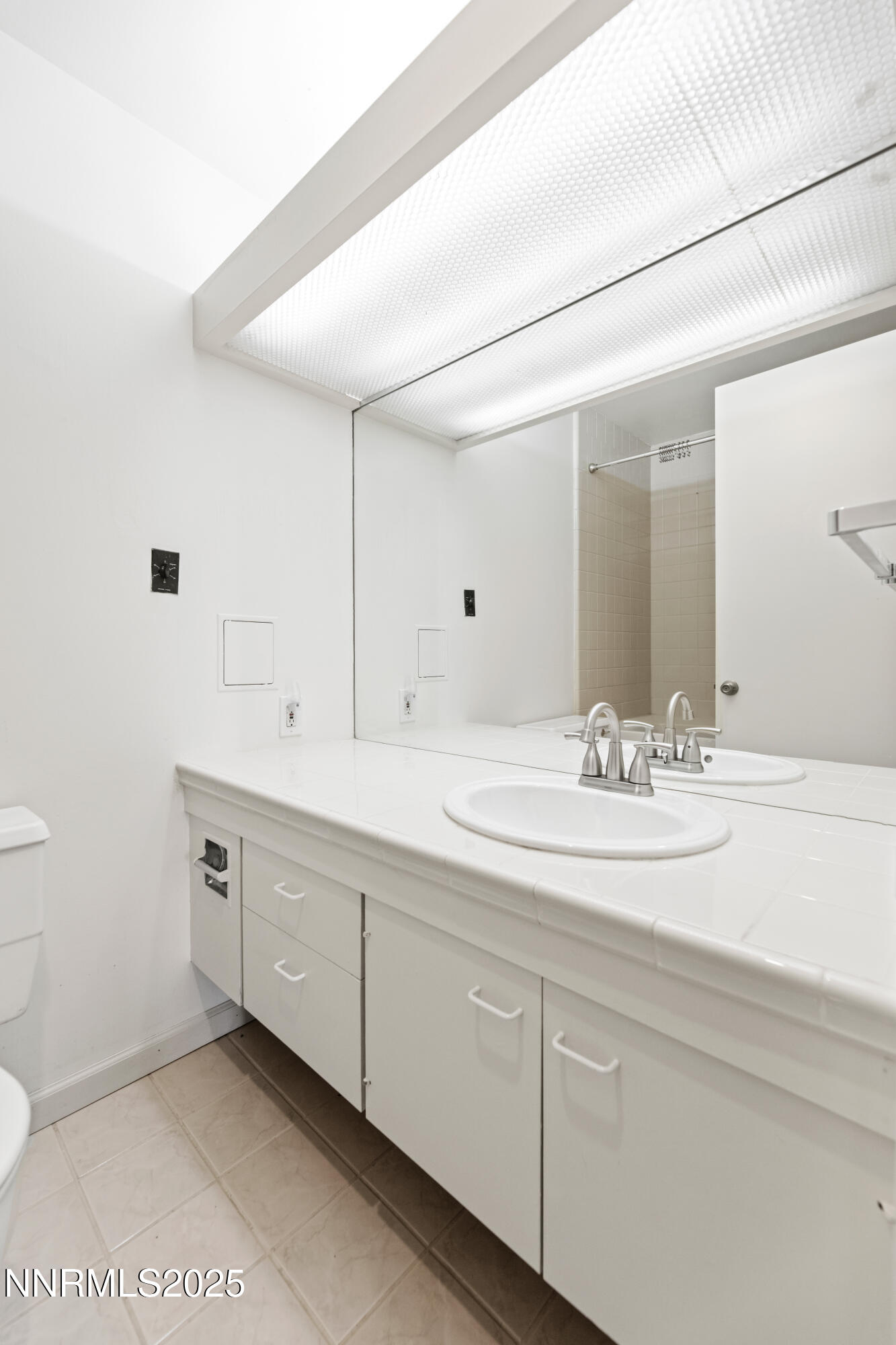 100 North Arlington Avenue, Unit 23P Reno, NV 89501 - Photo 18 of 31 a bathroom with a sink and a mirror