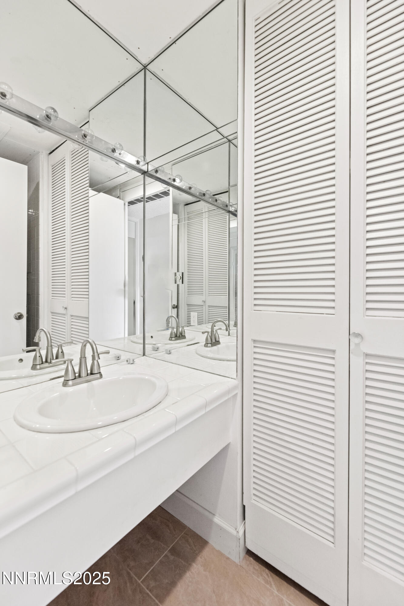100 North Arlington Avenue, Unit 23P Reno, NV 89501 - Photo 19 of 31 a bathroom with a sink and a mirror