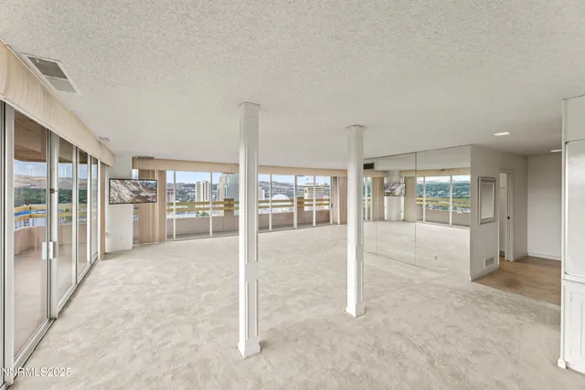 a view of a hall with wooden floor