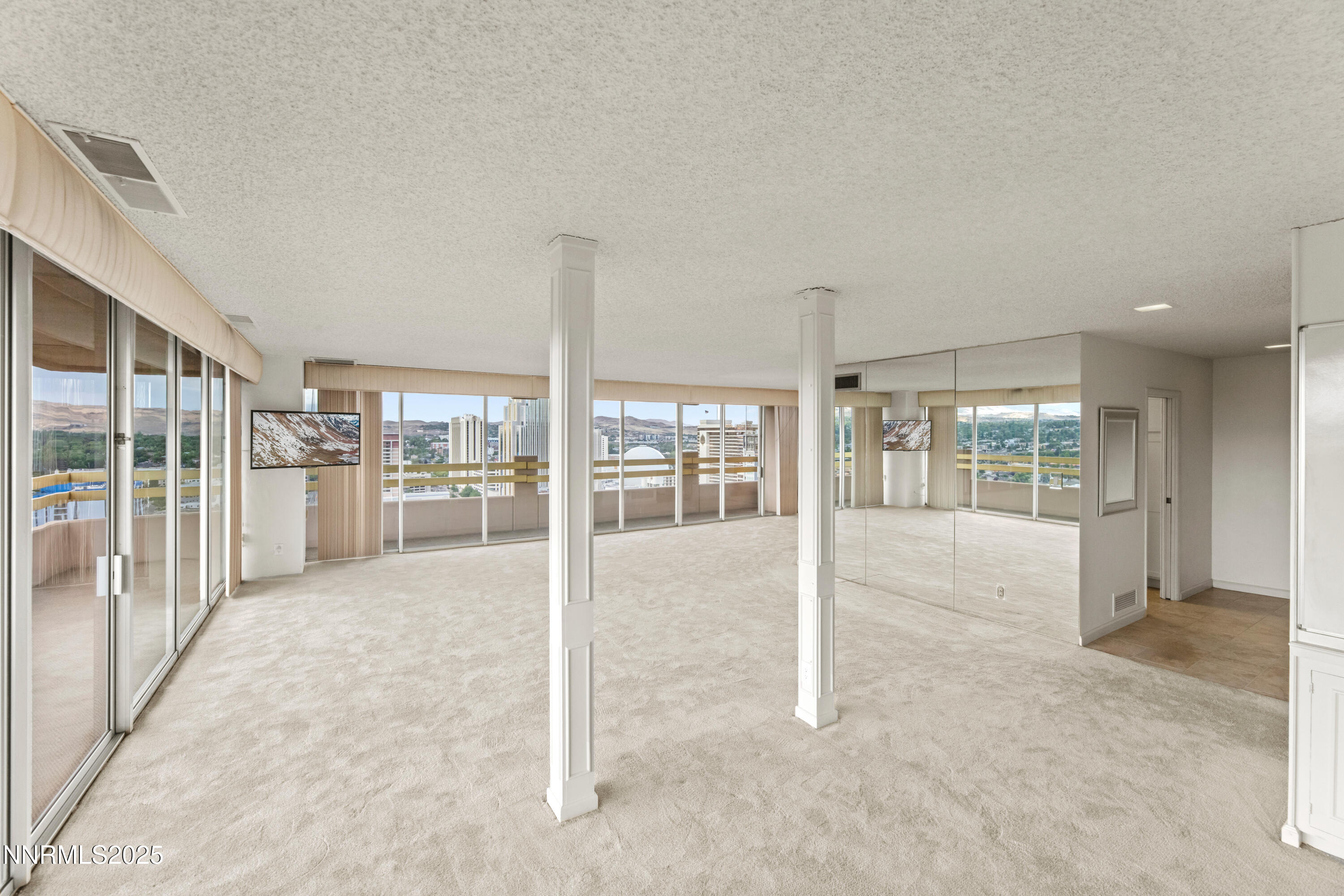 100 North Arlington Avenue, Unit 23P Reno, NV 89501 - Photo 4 of 31 a view of a hall with wooden floor