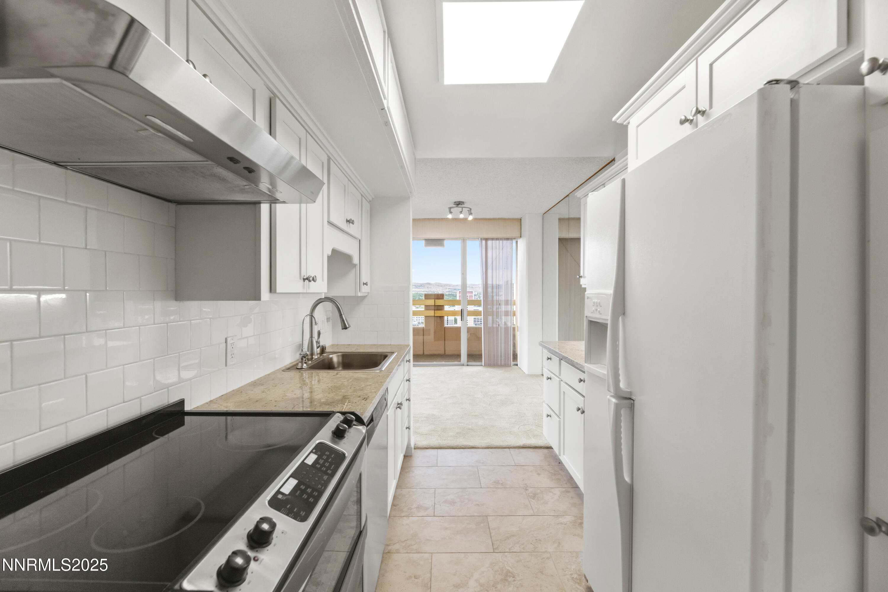 100 North Arlington Avenue, Unit 23P Reno, NV 89501 - Photo 9 of 31 a kitchen with stainless steel appliances granite countertop a refrigerator and a stove