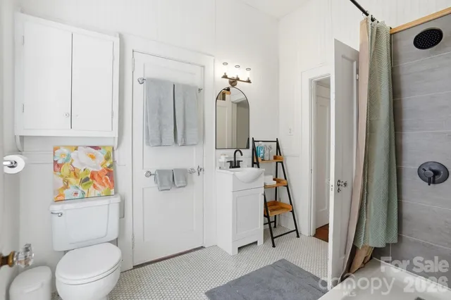 a bathroom with a toilet a sink and shower