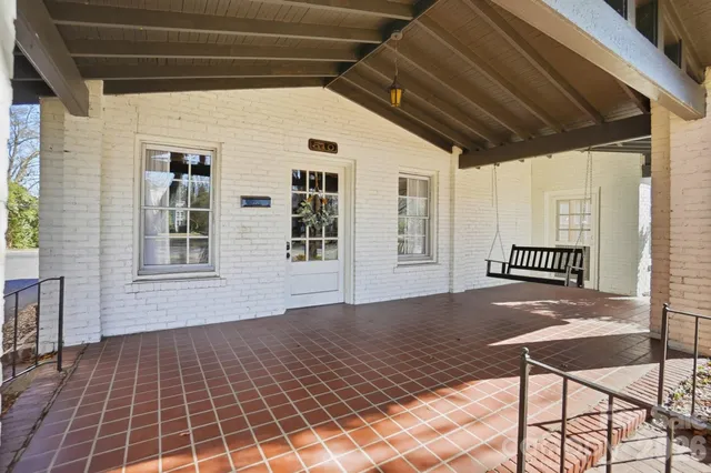 a view of a porch with wooden floor and a potted plant