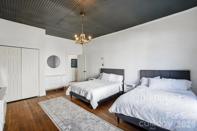 a bedroom with double bed and a chandelier