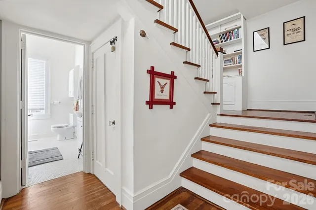 a view of a hallway with wooden floor and entryway