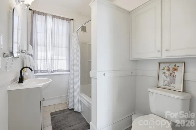 a bathroom with a sink toilet and tub