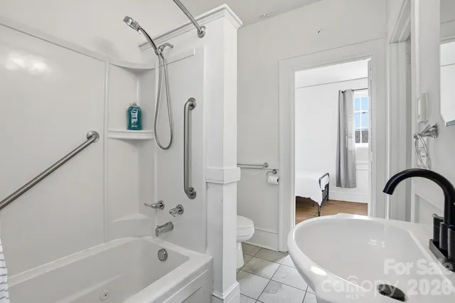 a bathroom with a sink a mirror toilet and bathtub