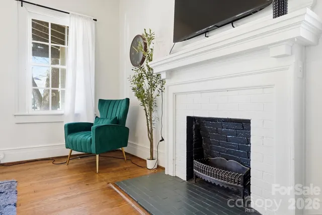 a front view of a house with wooden floor and a fireplace