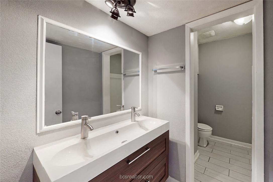 3300 South College Avenue, Unit A10 Bryan, TX 77801 - Photo 4 of 7 a bathroom with a sink and a mirror