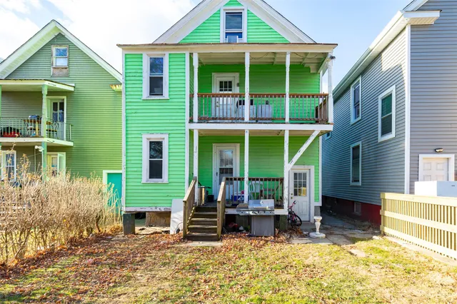 a view of a house with a patio and a yard
