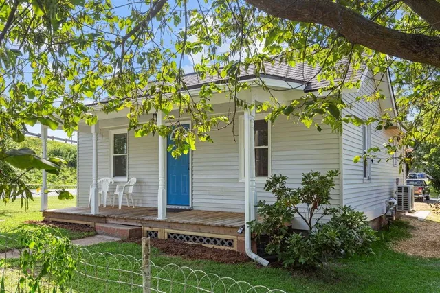 a house that has a tree in front of the house