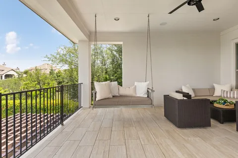 a view of a balcony with furniture
